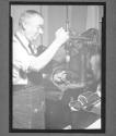 [Man with Drill Press]