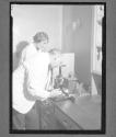 [Man and Woman Examine Lab Sample]