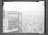 [Workers near top/ View of City]