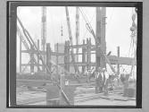 [Lifting a Beam with a Derrick]