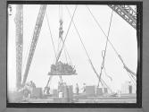 Raising Equipment on Derrick
