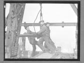 Workers Steering Girder in Place