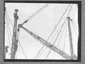 [Two Men on Derrick]
