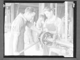 Two Workers oiling Grindstone