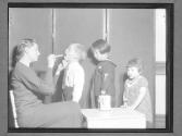 [Nurse Examines Children with a Tongue Depressor]