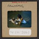 [Mimi Muray swimming with a woman (travel slide)]