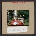 [Peggy Muray holding a dog (travel slide)]
