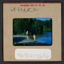 [Mimi Muray and woman standing near water (travel slide)]