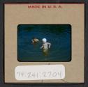 [Mimi Muray and a boy swimming (travel slide)]