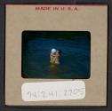 [Mimi Muray and a boy swimming (travel slide)]