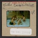 [Nicholas Christopher Muray and three children playing in sand (travel slide)]