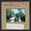 [Mimi, Peggy, and Nicholas Christopher Muray with a cat, California (travel slide)]