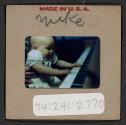 [Mimi Muray playing a piano (travel slide)]