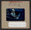 [Mimi Muray playing a piano (travel slide)]