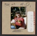 [Peggy Muray holding a dog (travel slide)]