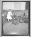 [Little Girl Feeding Chickens]