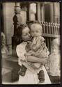 [Girl holding a baby in the steel district, Pittsburgh]