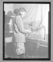Young Girl Working in Bottle Factory