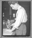 [Man Cutting Fabric with Machine]