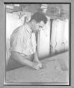 [Man Cutting Fabric]