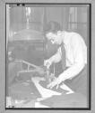 [Man with Hand Press]