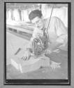 [Man Cutting Cloth]