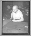 [Man Cutting Fabric]