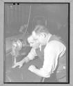 [Two Men Cutting Fabric]