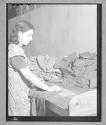 [Woman Measuring Shirt]