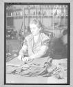[Older Woman Folding Fabric]
