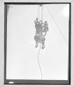 Two Men Riding Ball