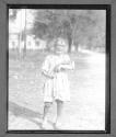 Child Poorly dressed holding doll