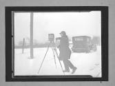 [Lewis W.  Hine with camera in snow]
