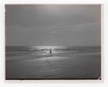 [Two figures on beach]
