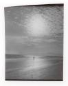 [Figure on beach]