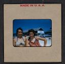 [Mimi Muray and a woman posing on a beach (travel slide)]
