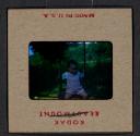 [Mimi Muray on a swing (travel slide)]