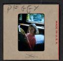 [Peggy Muray reading a newspaper (travel slide)]