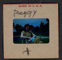 [Peggy Muray seated outdoors (travel slide)]