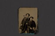 [Two men in hats posing in studio]