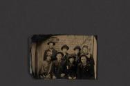 [Group of men and women posing in studio]