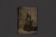 [Woman posing with chair in studio]
