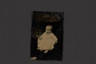 [Infant seated in chair in studio]