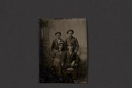 [Four men posing in studio]