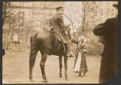 [Mounted policeman, Elisabeth Freeman petting horse]