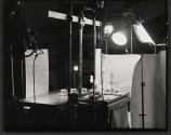 [View of interior of Nickolas Muray's studio with props and equipment setup]