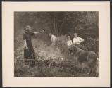 [Woman warning dog away from brush fire]