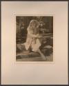 [Seated woman wearing hat]
