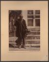 [Older man with cane standing in front of steps]