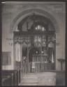 [Carved rood screen in church]